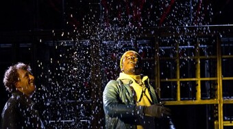 Performer looking a snow falling on stage