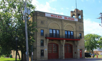 A brick building with a sign that reads "mixed blood."