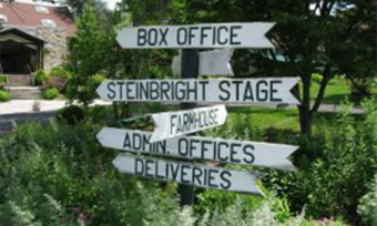 An outdoor sign pointing toward several offices.