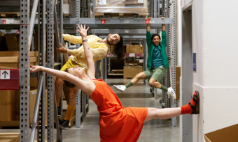 three people posing for a photo in an ikea warehouse