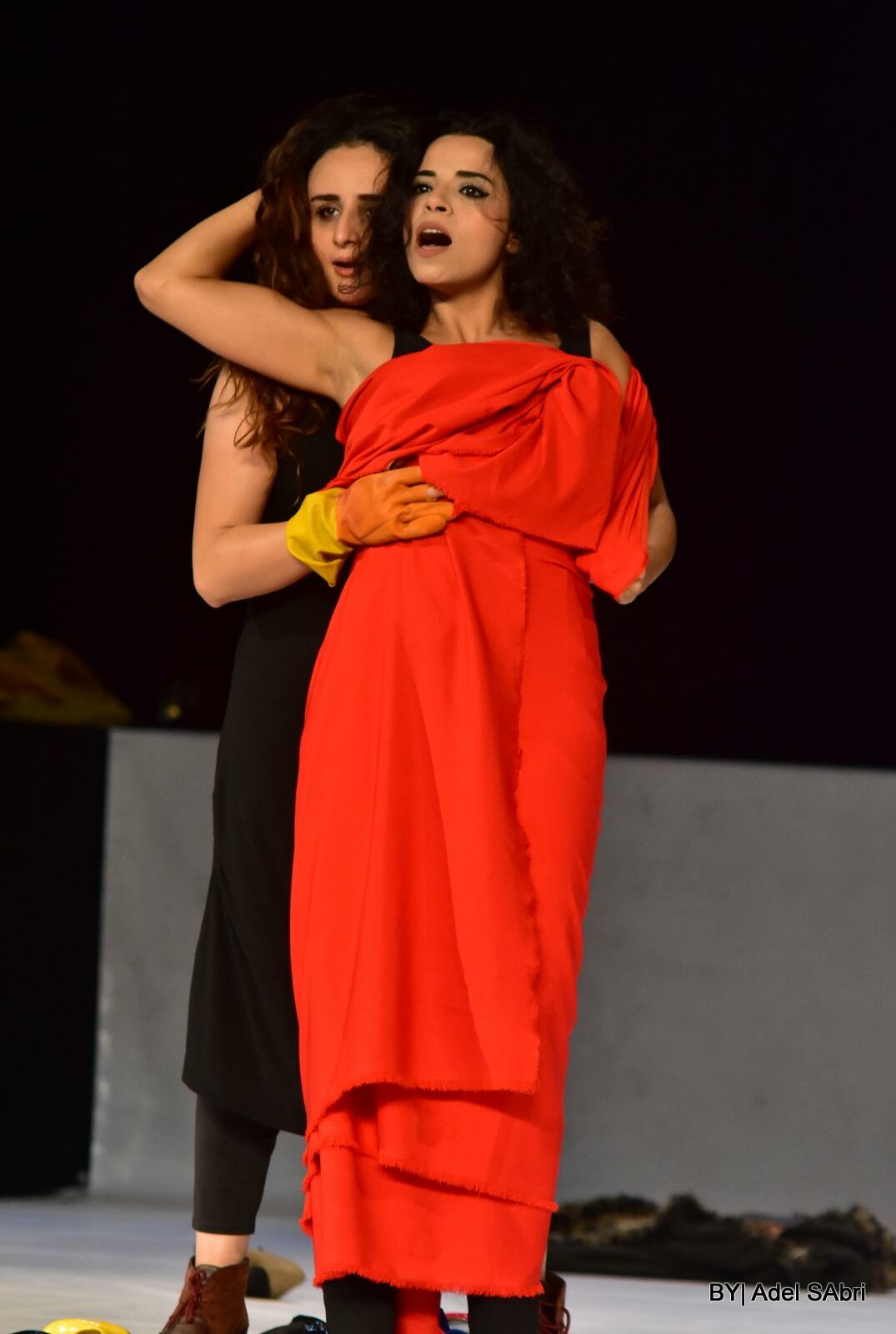 two female performers embracing