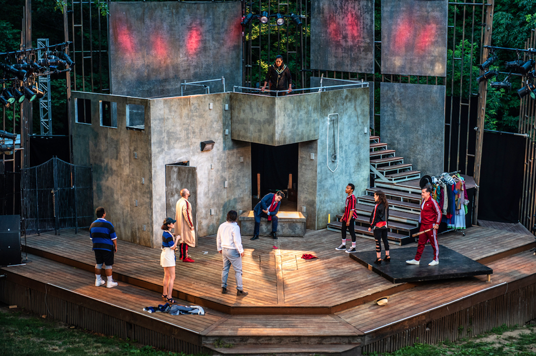 nine actors on an outdoor stage