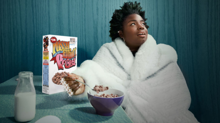 a person sitting in a bathrobe eating breakfast cereal