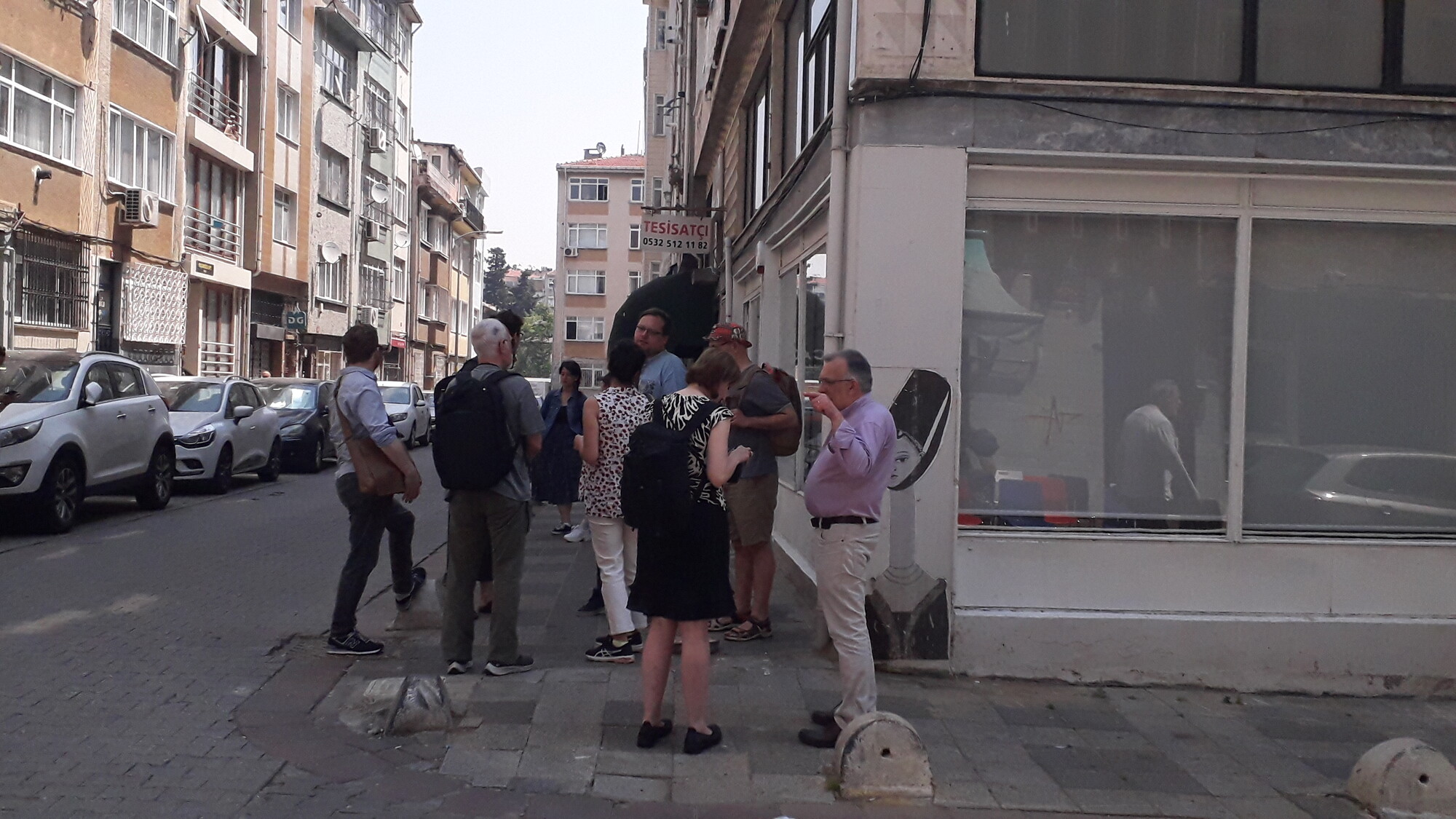 Several audience members gathered on the street discussing the show with one another.