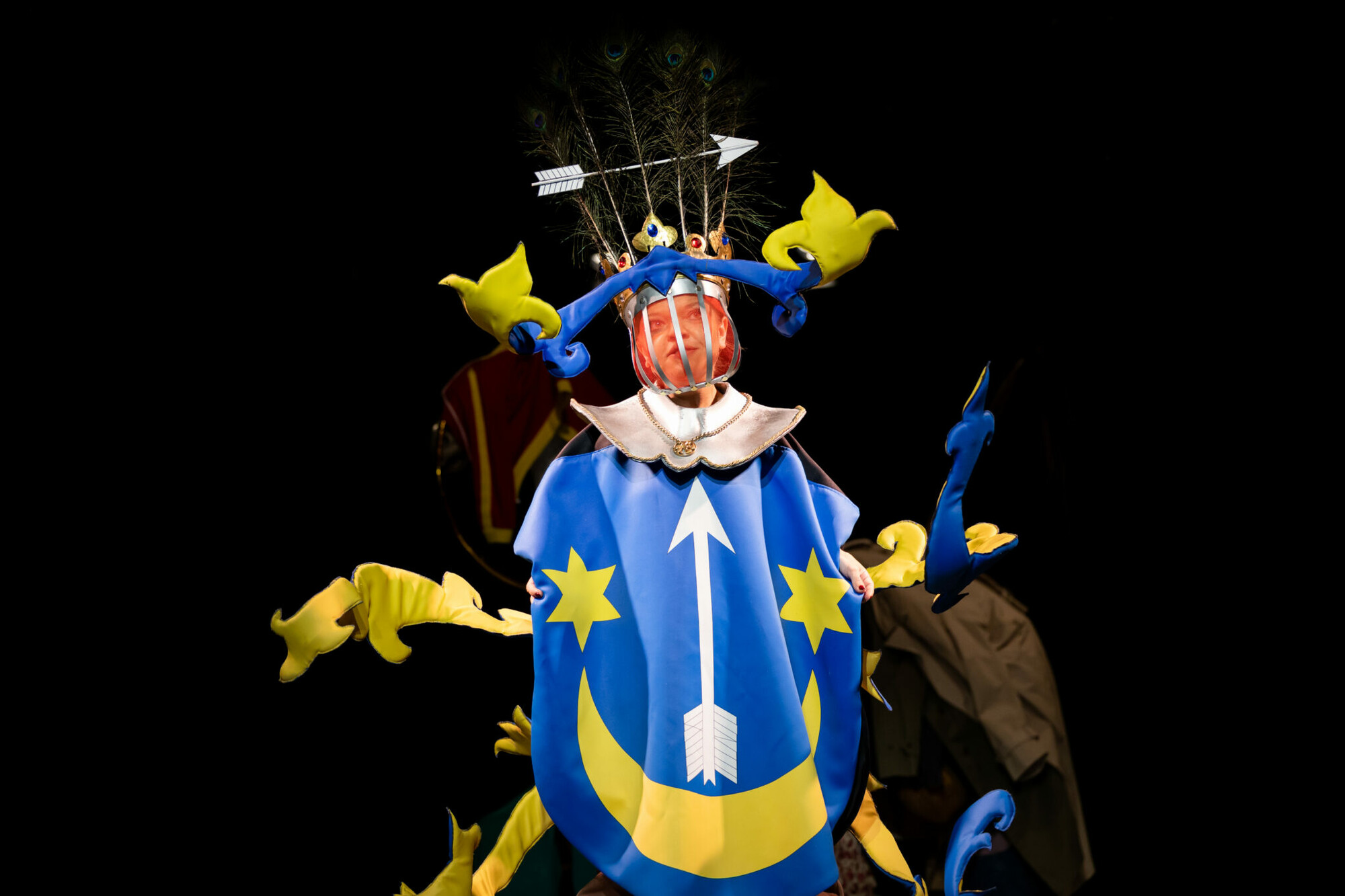 An actor in a bright blue and yellow costume.