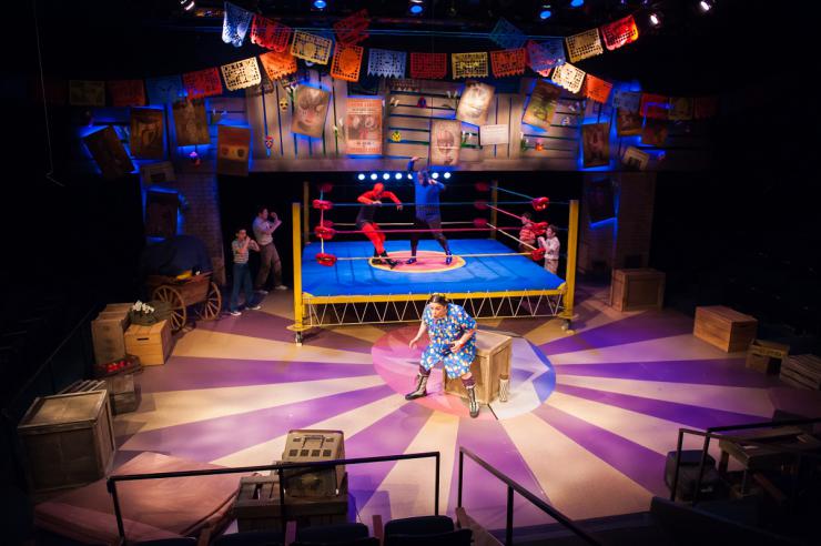 Actor on stage in front of a wrestling ring