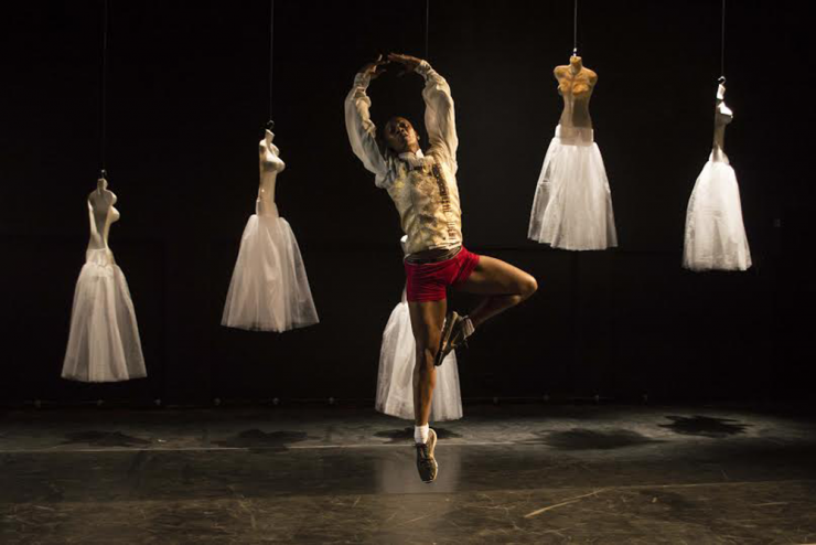 Ballet dancer in front of floating mannequins