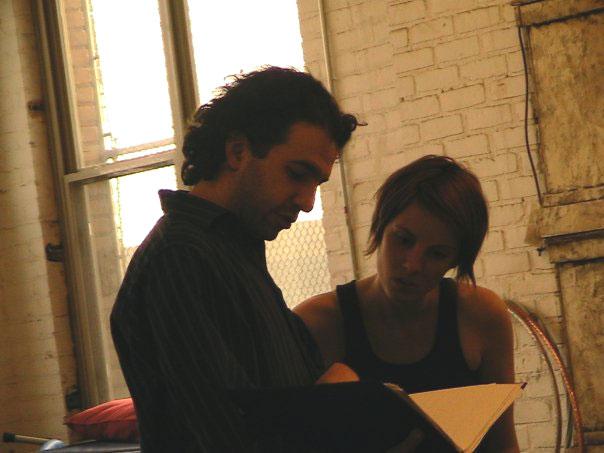 A man and women looking at a script 