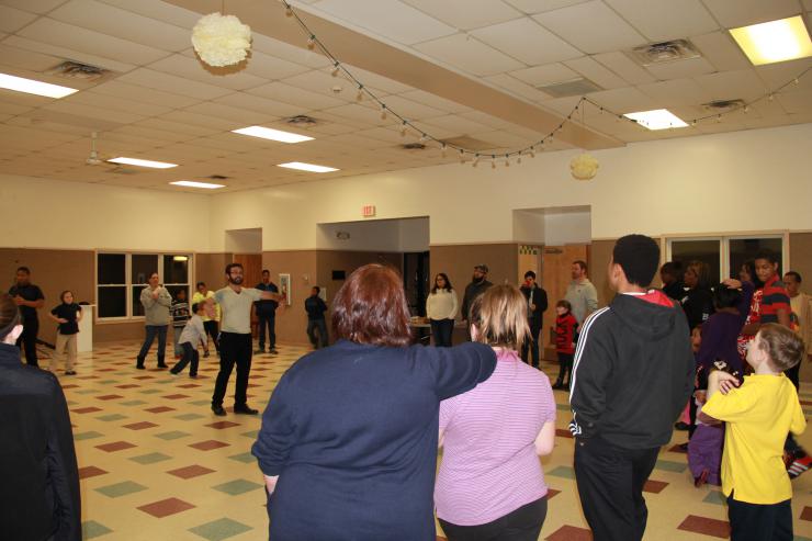 People standing in a circle rehearsing