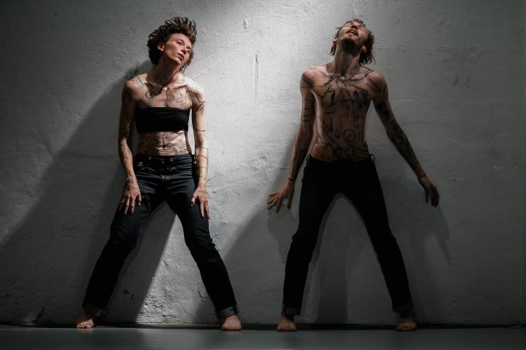 two people dancing with their bodies painted