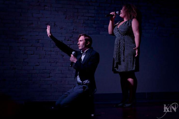 two actors singing on stage