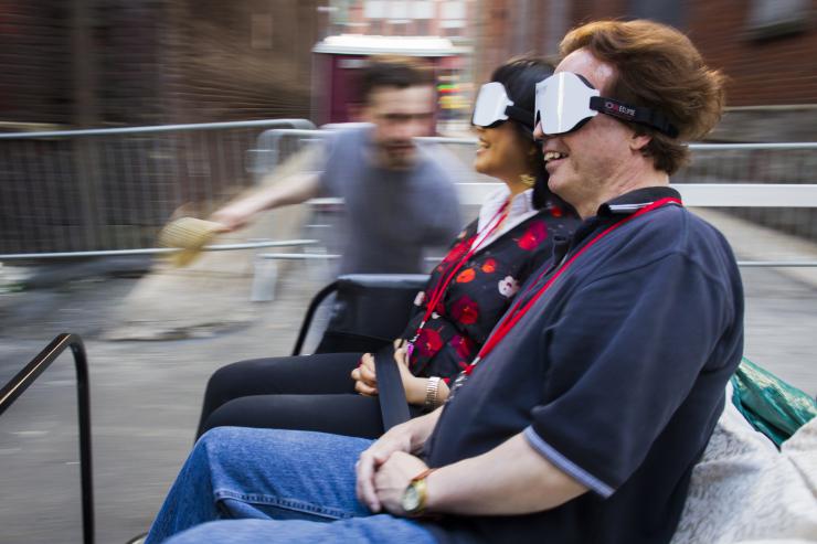 two people driving a car with virtual reality goggles