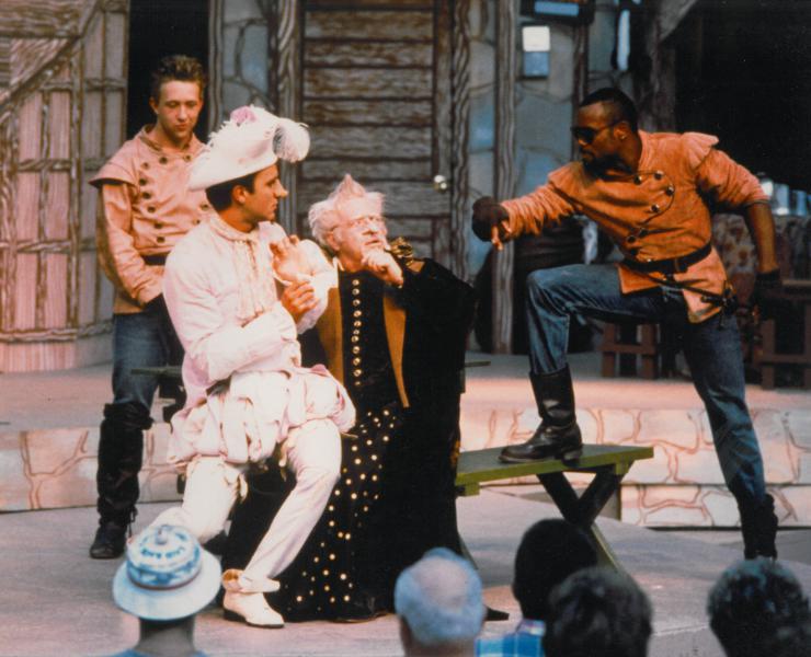 a group of actors arguing on stage