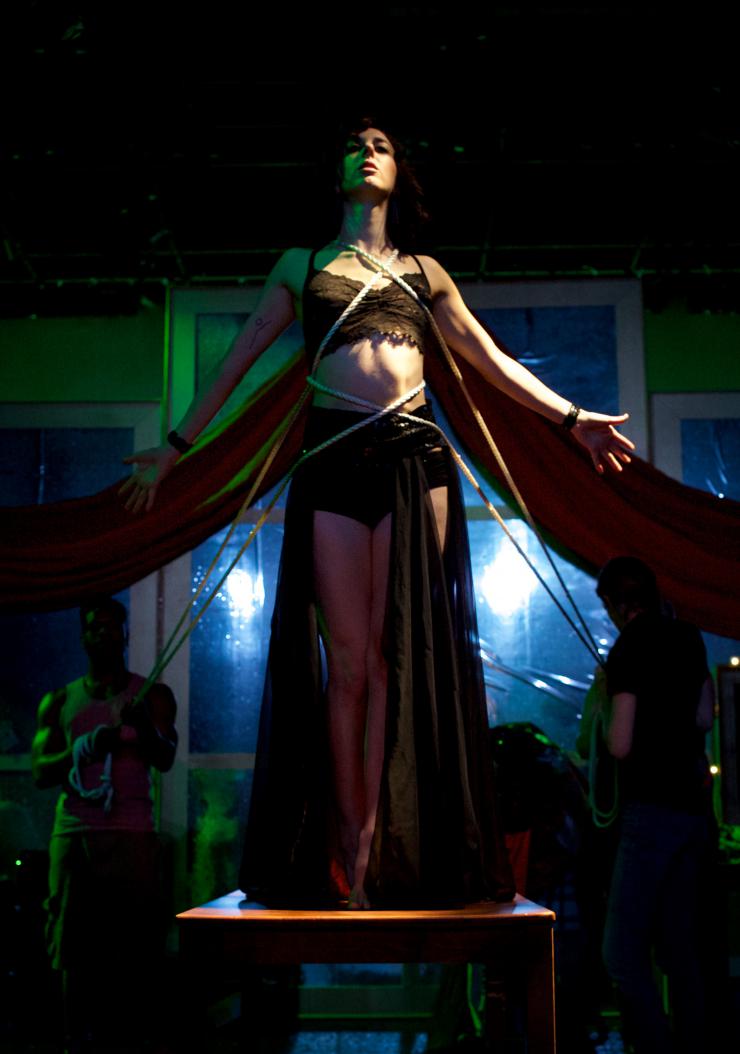 a woman held with ropes on stage