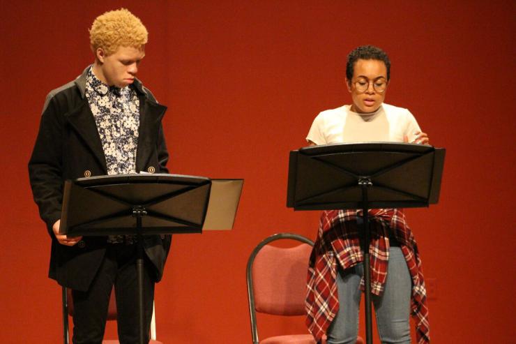 two actors performing in a staged reading