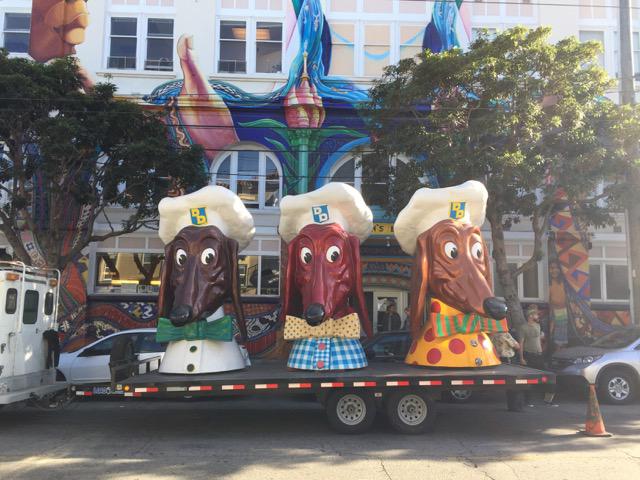 Three large fake dog heads on a truck 