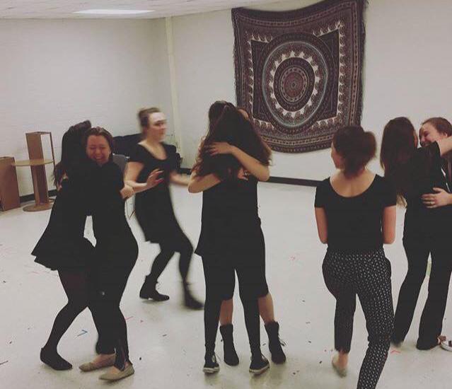 students hugging and dancing in rehearsal