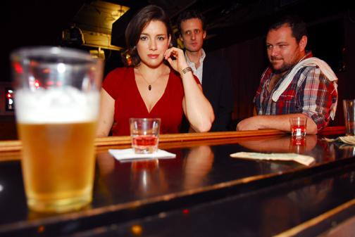 three actors in a bar scene