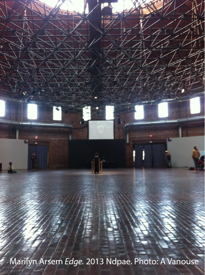 A large, empty circular room with exposed beams on the ceiling. 