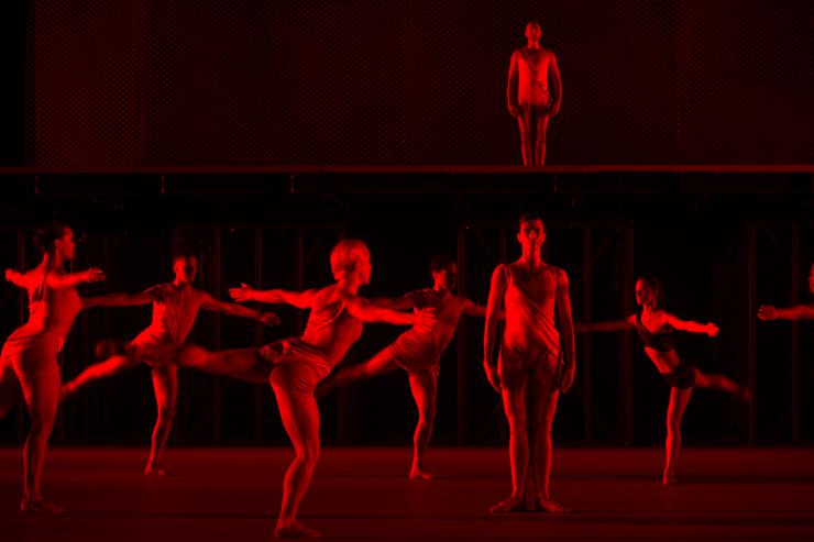 Ballet dancers performing in red light
