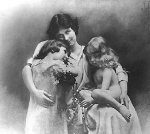 A black and white photo of a mother with children.
