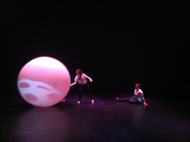 A giant ballon on stage with two women