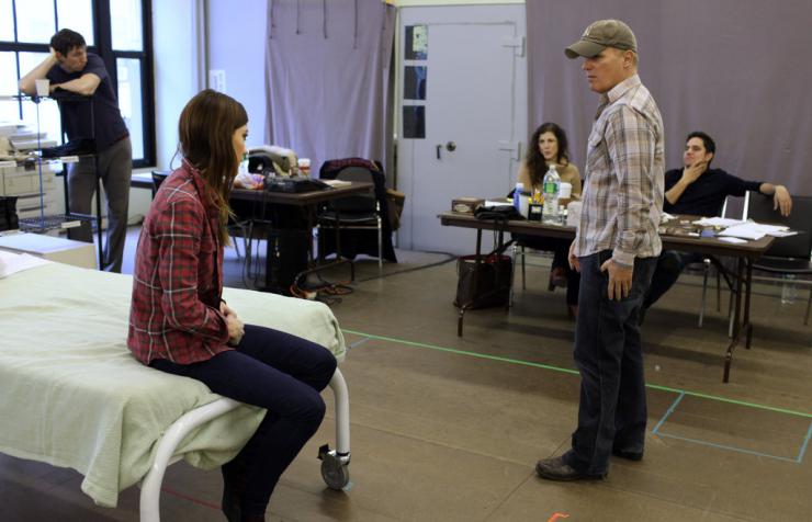 Two actors rehearse for a play.