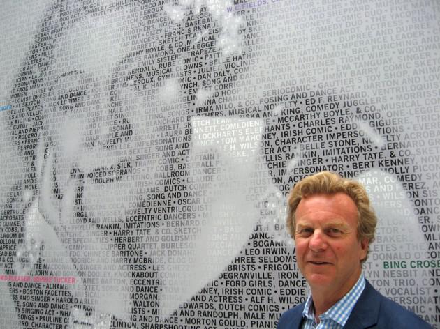 Robert Orchard in front of a mural.