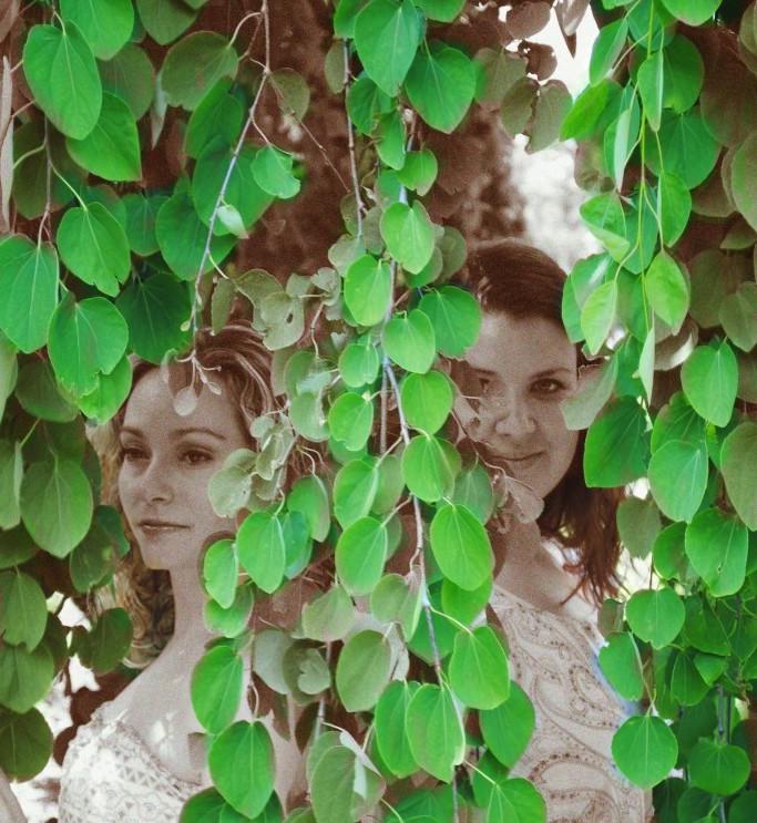 two women hidden in vines