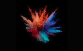 Colored powder bursting on a dark background.