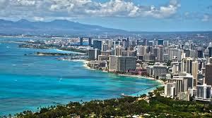 The city of Honolulu framed by the ocean and mountains in the distance.