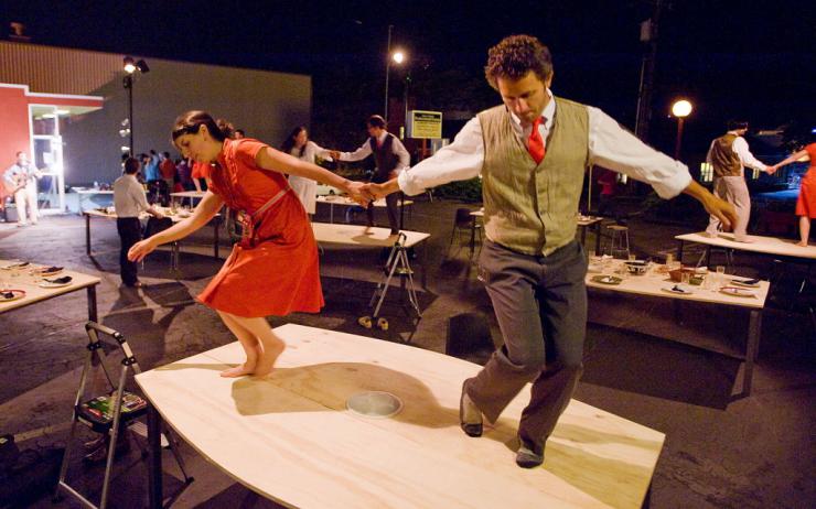 actors dancing on a table 