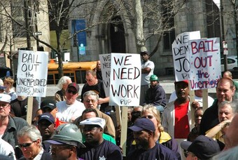 People with signs protesting unemployment in the United States. 