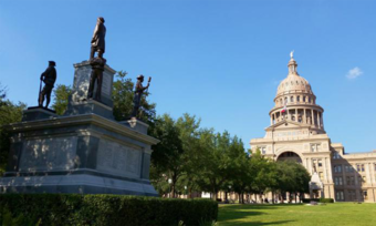 A statue and the Capitol building in Austin, Texas.