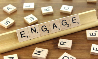 Scrabble letter arranged to spell the word engage.