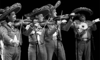 A black and white photo of a mariachi band.