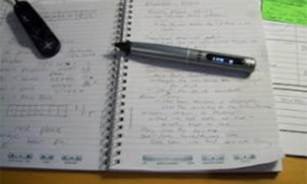A notebook with the LiveScribe pen on top of it.