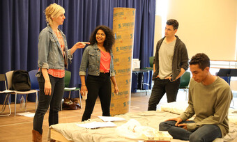 director in rehearsal with three actors