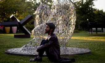 A man in a sculpture garden.