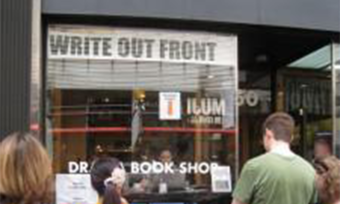 Several people stand outside a shop with a sign that says "Write Out Front."