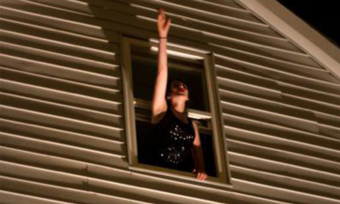 A person waving out of a window.