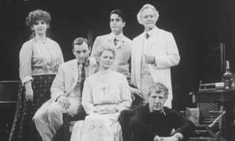 A black and white photo of five actors in Edwardian costume and their director.