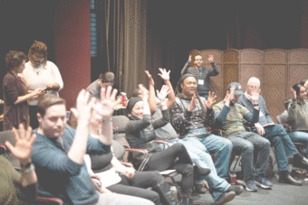 group of people applauding in ASL