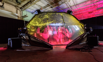 audience members inside an enclosed transparent VR tent