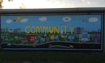 a colorful mural that says community