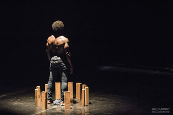 dancer standing on stage with back to audience