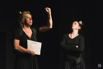 two performers on stage in Rovegan