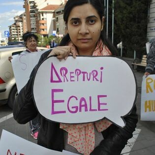 A woman holding a protest sign