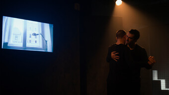 two people dancing in a dark room.