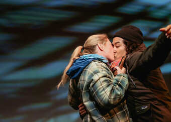 Two actors kissing on stage.